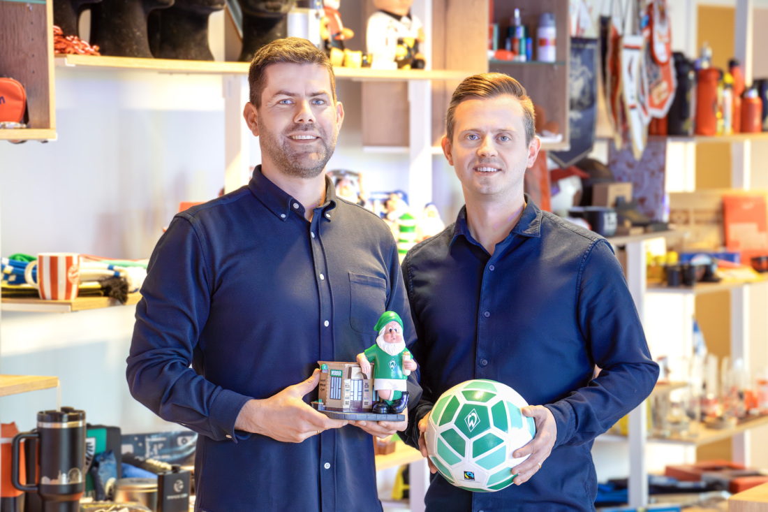 Ole Blöhm und Roman Freudenberg halten Fanartikel in der Hand Ole Blöhm und Roman Freudenberg halten Fanartikel in der Hand